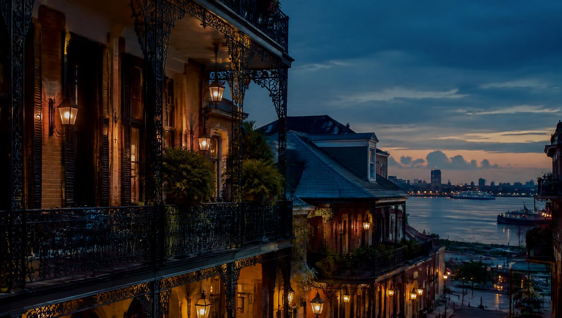 Wrought-iron balconies of New Orleans at dusk overlooking the Mississippi River